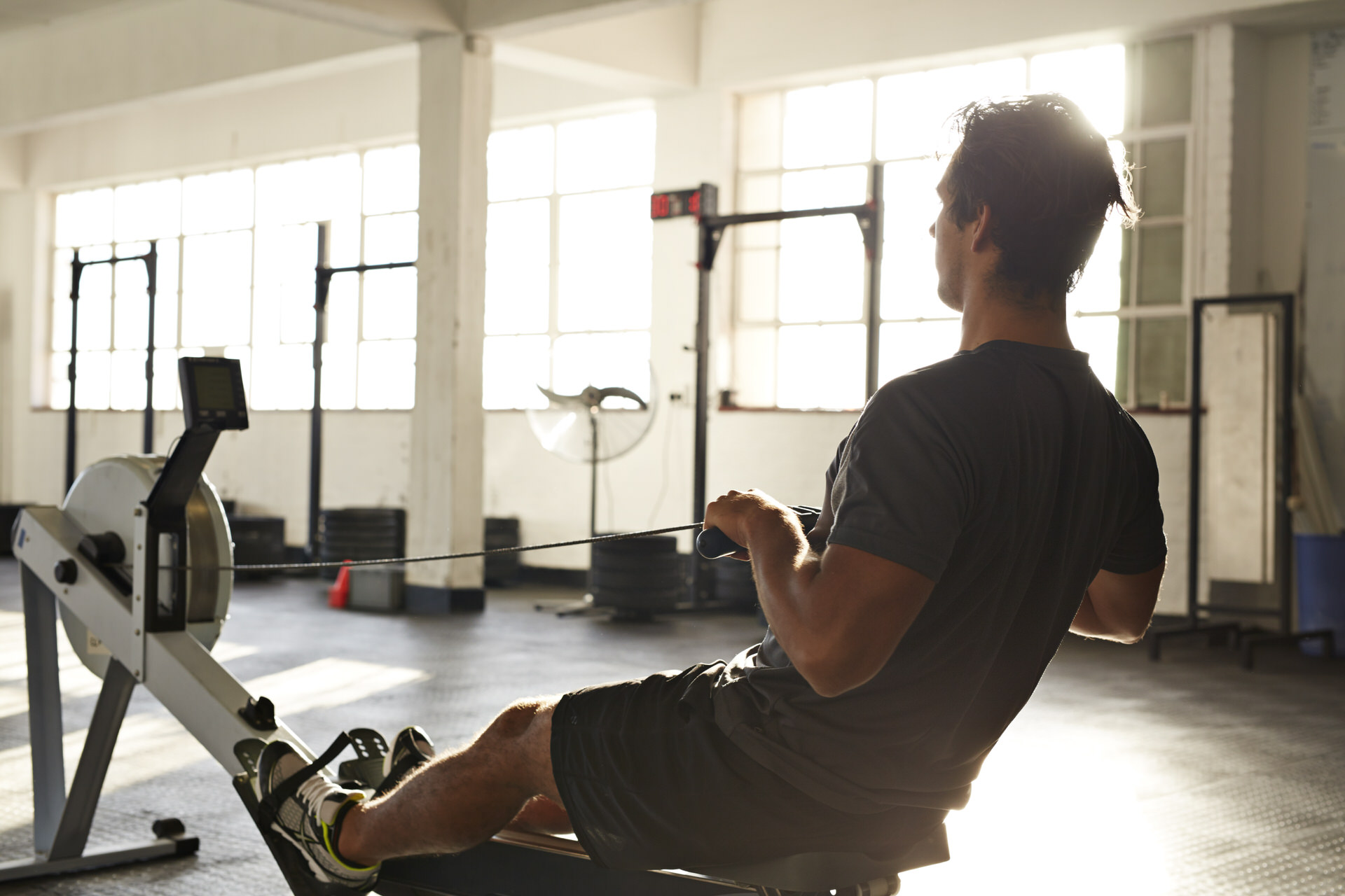Man Working Out Using Rowing Machine