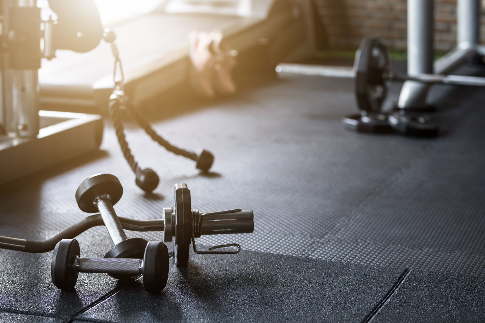 Gym Background Fitness Weight Equipment On Empty Dark Floor